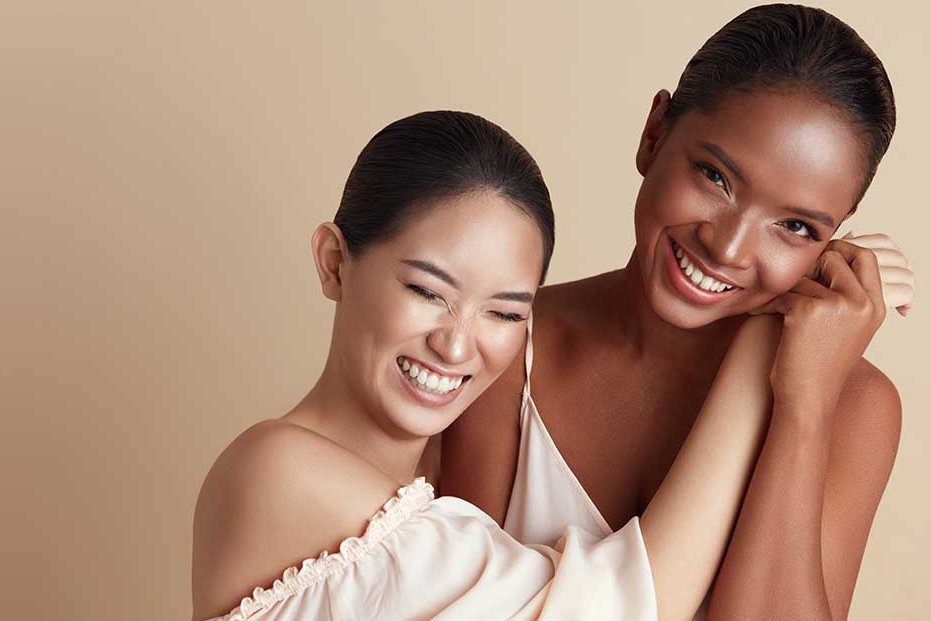 Two smiling women with radiant skin